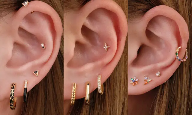 Ucho z kilkoma kolczykami, w tym ozdobnym kolczykiem typu anti tragus z czarnym kamieniem.